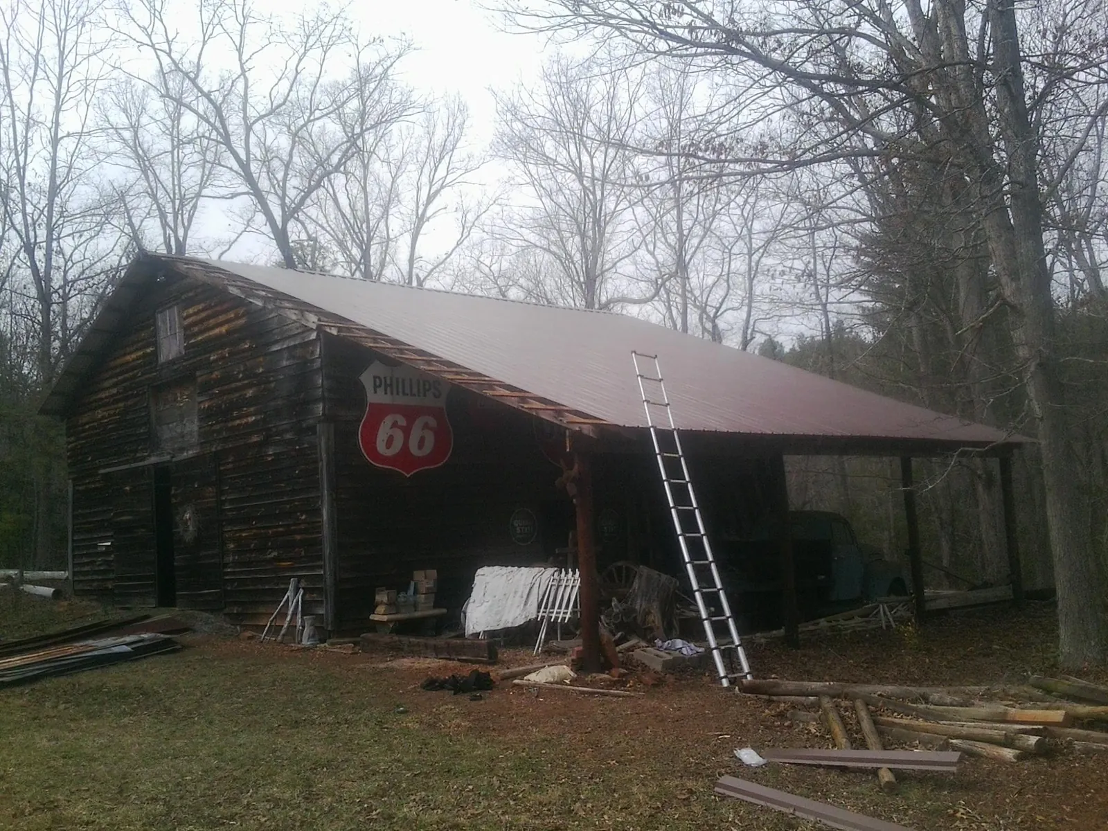 New metal roof on an open sided timber barn with a vintage sign in Belmont
